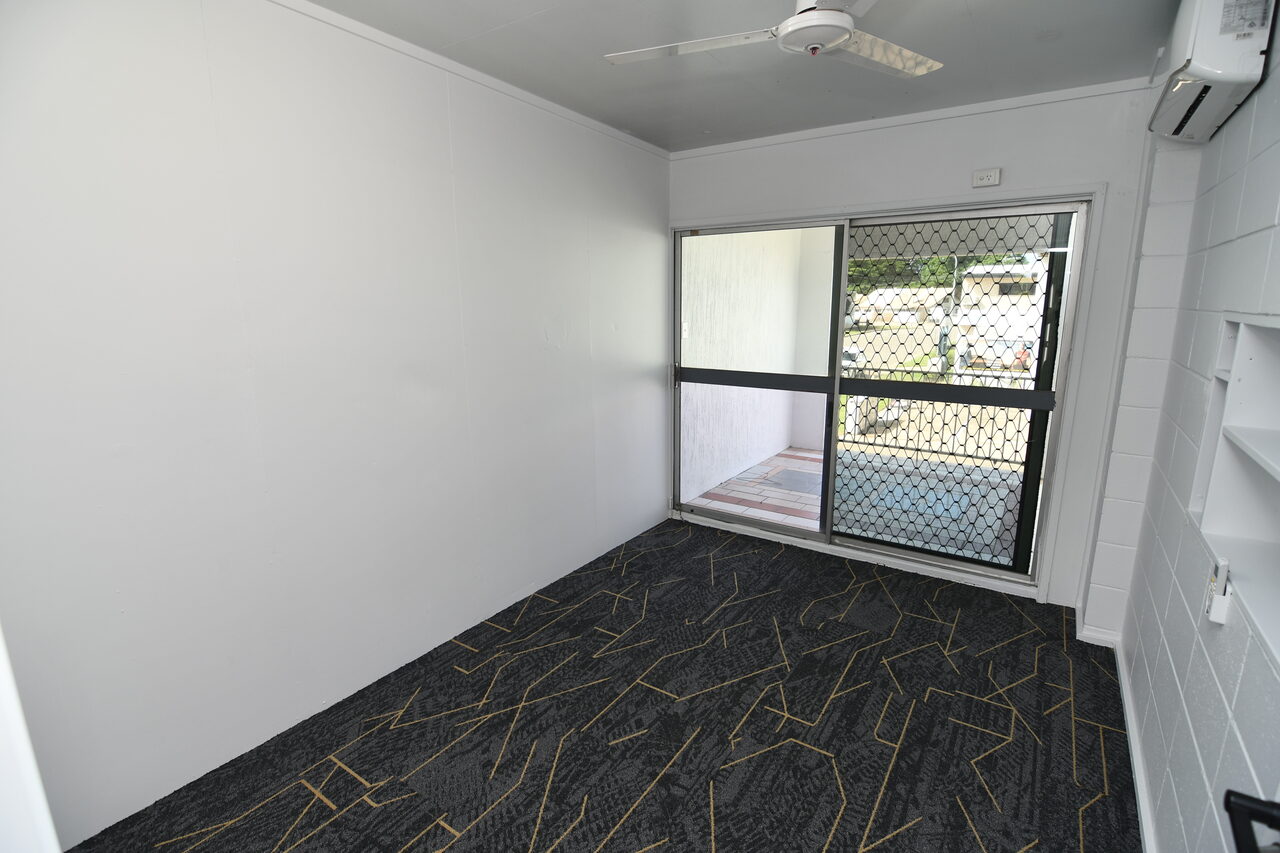Office 1 — private enclosed office with sliding door to balcony and natural light