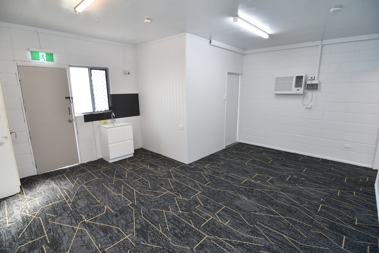 Reception area — entry to the first-floor office, kitchenette, sink and storage on arrival