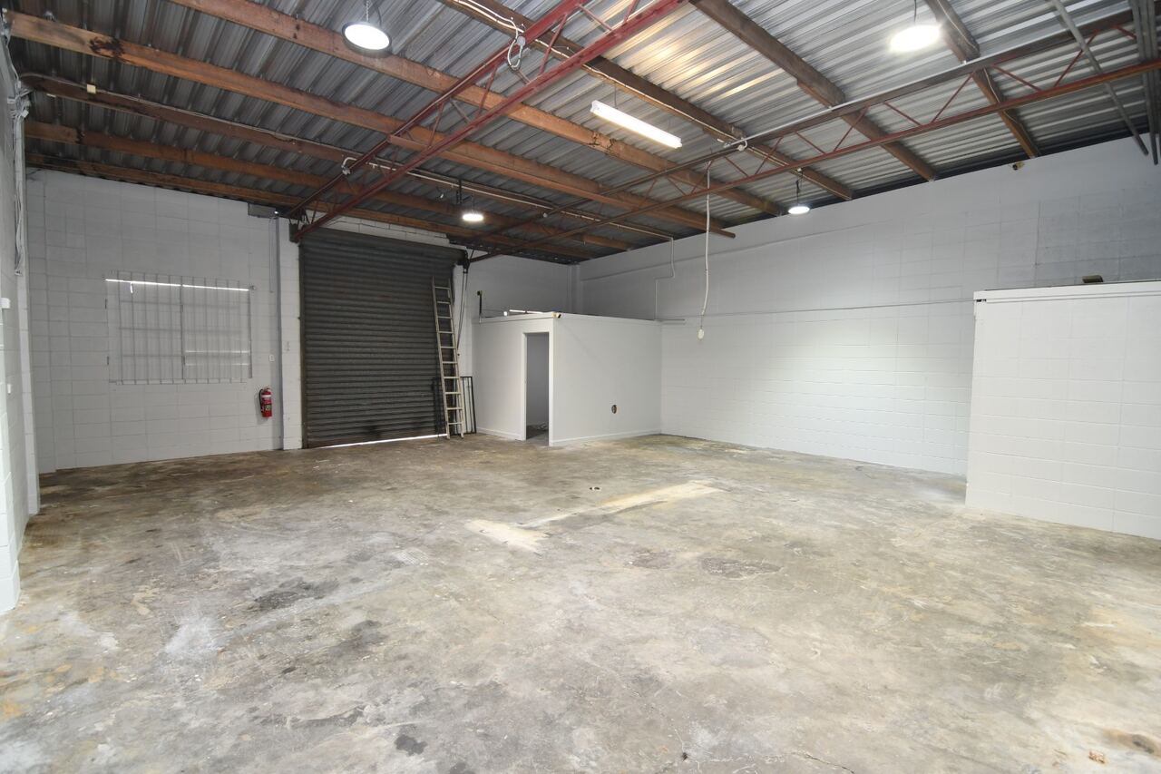 Warehouse interior — roller door from inside showing full workspace depth